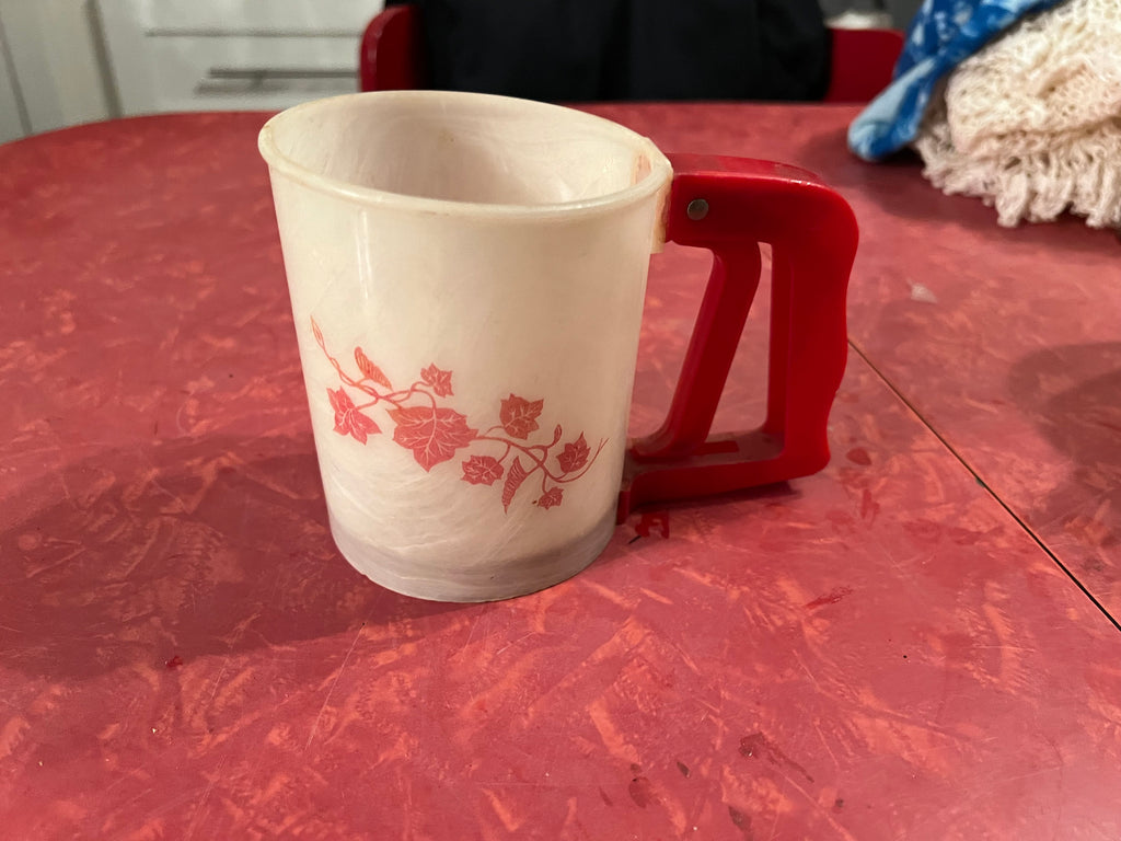 Vintage red plastic flour sifter