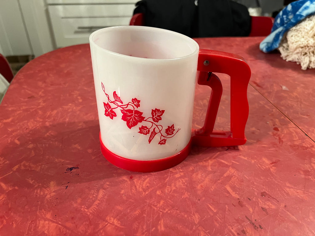 Vintage red plastic flour sifter